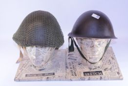 Two British army turtle helmets, green and black,