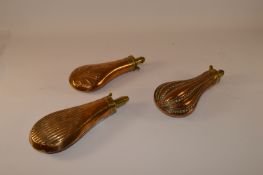 Three 19th century embossed copper powder flasks approx 20cm Condition Report