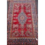 Persian rug, blue pole medallion on red field, featuring repeating boteh motif,