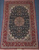 Persian Isfahan rug, central floral medallion on blue field of interlaced floral motifs,