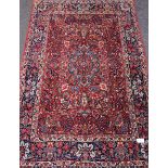 Persian Qum rug, red ground, overall floral design, boteh and flowers and vase motifs,