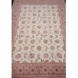 Persian Tabriz rug, beige field with all over stylised floral decoration,