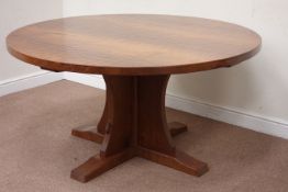 'Mouseman' oak circular adzed top dining table raised on cruciform base,