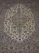 Persian Kashan rug, large central medallion within beige all over floral decorated field,