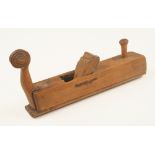 An early European fruitwood round soled plane 12" x 2 1/4" with attractive scroll carved front tote