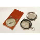 A steel cased prismatic compass with folding sights and a wood cased compass (Jay Gaynor