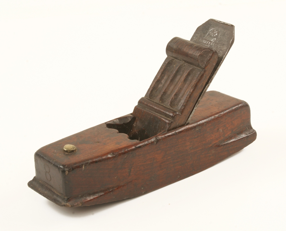 An early European mahogany compass plane 8" x 2 1/4" with distinctive carved wedge (illustrated