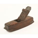 An early European mahogany compass plane 8" x 2 1/4" with distinctive carved wedge (illustrated