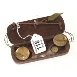 An early guinea balance with two weights marked 21s and 10s6d in wood case some rust G