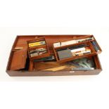 A draughtsman mahogany chest 34"x10"x6" containing a drawing set, rules,stencils, French curves,