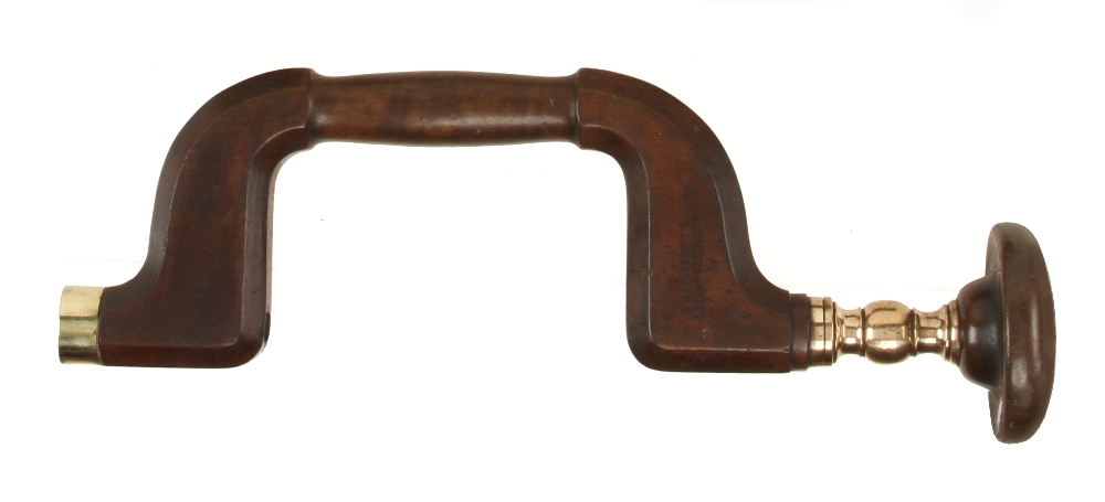 An early French fruitwood pad brace with very attractive turned brass baluster by AUX MINES DE