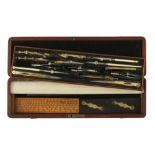 A mid Victorian brass drawing set with 2 ivory rules beneath, not all original,