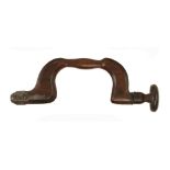 An early iron button pad beech brace by FREETH with 18c style pad decoration,