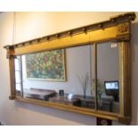 An early 19th century gilt landscape mirror, the sides moulded with pillars with classical capitals,