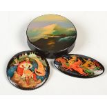 A USSR small circular lidded box, the lid painted with a view to mountains, paper label marked