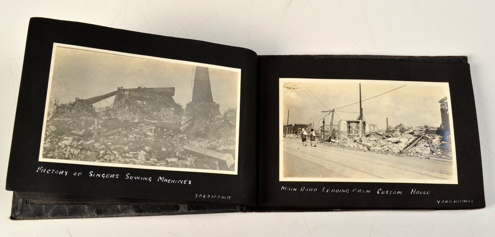 A small photograph album, gold embossed with "THE GREAT EARTHQUAKE YOKOHAMA. 1-9-23. JAPAN. H.M.S. - Image 2 of 2