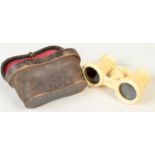 A pair of ivory opera glasses in original leather case.