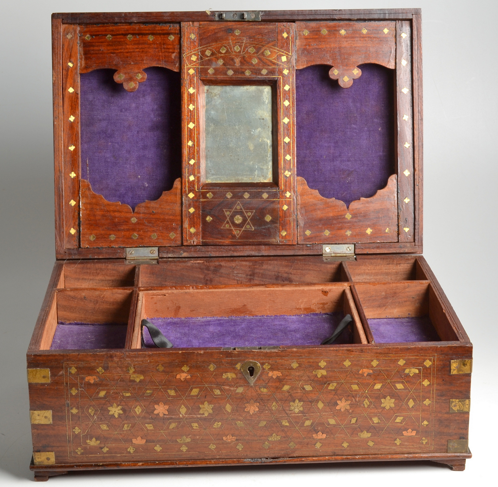 An Indian brass inlaid work box, circa 1900, decorated with floral motifs,