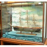 A wooden scale 1:100 model of The Cutty Sark, length 75cm, in a glazed case width 92cm.