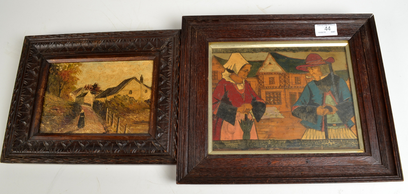 A small oil on board of a figure by farm buildings and a Dutch wood panel carved with figures