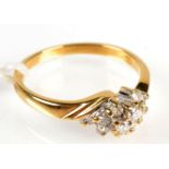An 18ct. gold crossover cluster diamond ring.