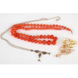 A citrine and seed pearl necklace, damaged, a coral necklace and one other necklace.