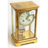 A brass corniche four glass clock, retailed by Camerer Kuss & Co, London,