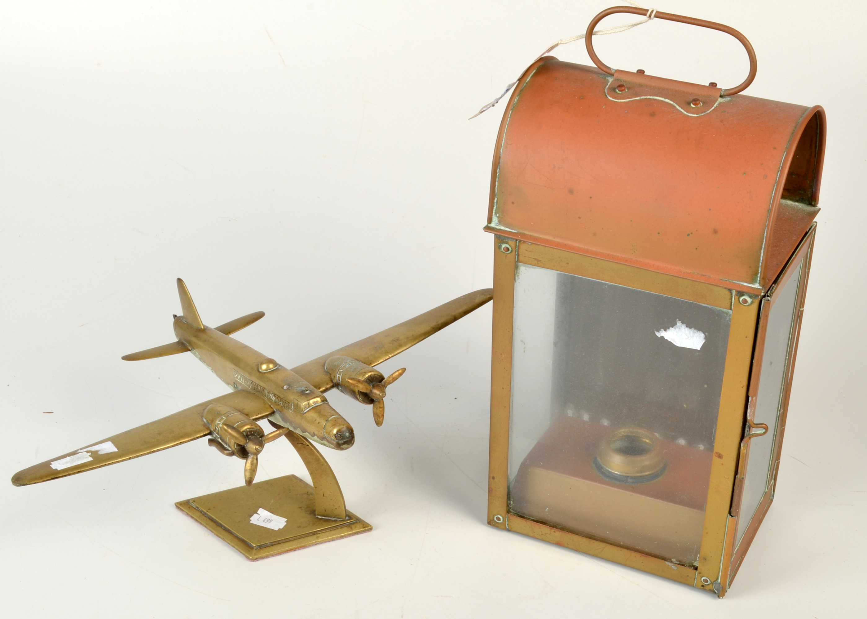 A brass model of a WWII twin engine bomber, wing span 35cm. and a brass companion way lamp.