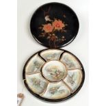 A Japanese porcelain hors d'oeuvres set within the original black lacquered circular case,