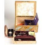 A silk covered jewellery box with costume jewellery etc. including a miniature dolls head.