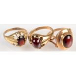 Three 9ct. gold rings, each set a garnet.