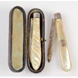 A Victorian silver bladed folding fruit knife with fluted mother of pearl handle and leather