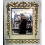 An ornate carved and gilt mirror on cream painted ground, 96 x 76cm.