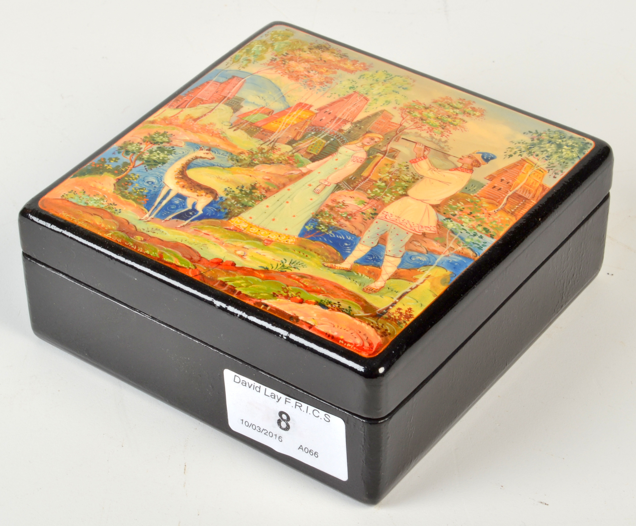 A Russian lacquered box, the lid painted with a piper and girl watched by a deer in a landscape