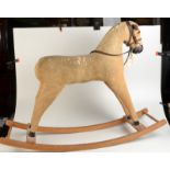 A corduroy covered rocking horse with wooden nose and feet on bentwood rockers, height 78cm.