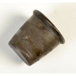 A Britannia Metal tot in the form of a thimble and inscribed 'Just A Thimble Full'.