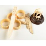 A set of four Chinese carved ivory napkin rings etc.