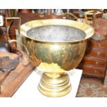 A massive brass twin handled urn, diameter 50cm.