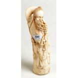 An early 20th century Japanese ivory carving of a bearded scribe,