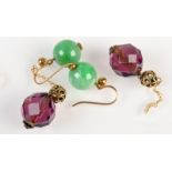 A pair of jade earrings and a pair of amethyst earrings.