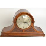 A large carved mahogany mantle clock with Westminster chime.