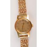 A ladies Omega, gold cased wristwatch with 9ct gold bracelet strap.