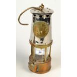 A miner's chrome and brass lamp by The Protector Lamp & Lighting Co. Ltd., height 24cm.