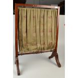 An inlaid fire screen with a floral fabric panel.