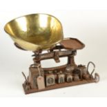 A grocer's balance with brass pan and iron stand, together with seven square section,