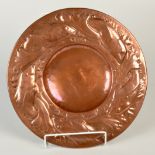 A Newlyn Copper, Industrial Class, circular alms dish, the wide border is relief decorated with fish