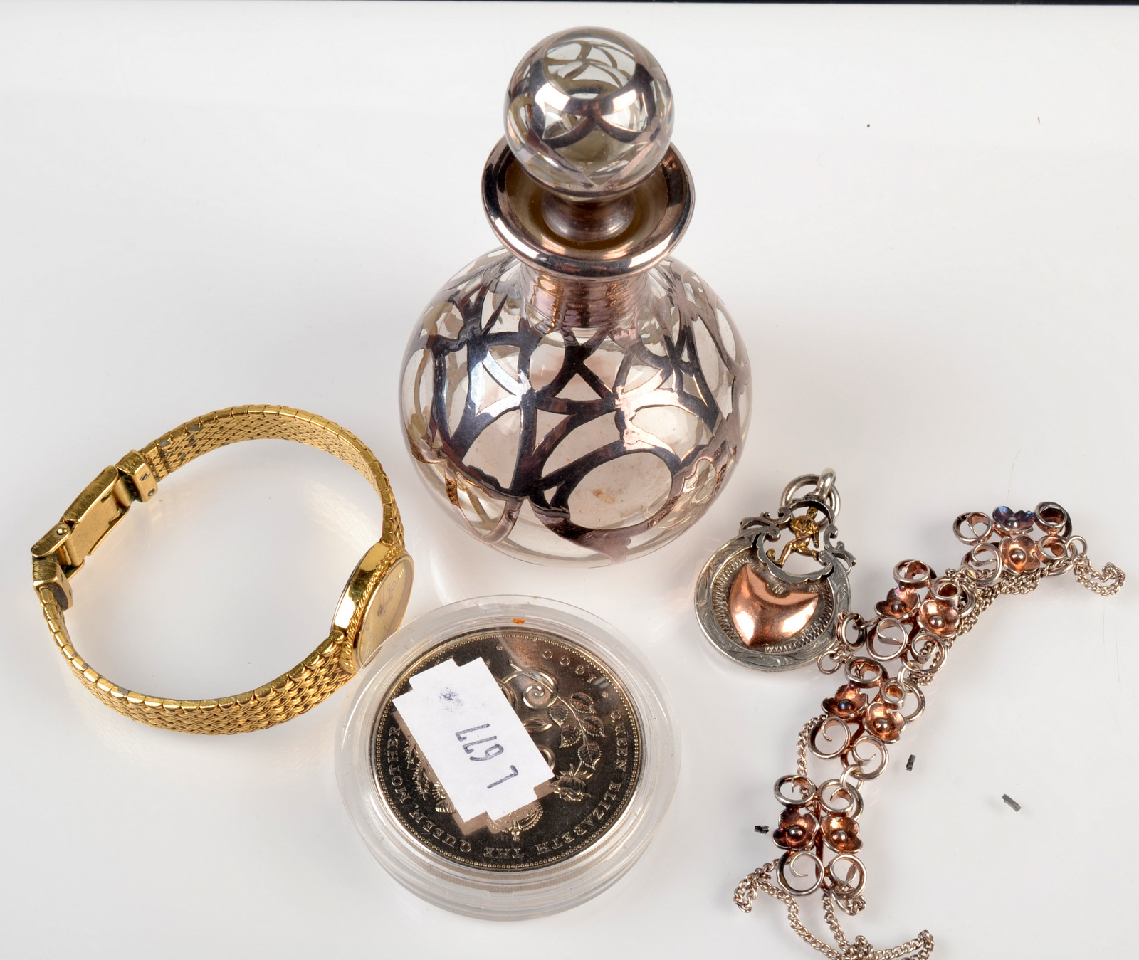 A post war Arts and Crafts silver necklace, together with a silver encased perfume bottle,