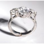 An exceedingly fine three stone diamond ring on a white platinum Jacob Newman & Co expanding shank.