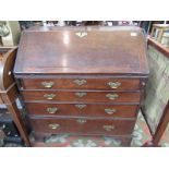 An 18th century oak, slope front, bureau, fitted with four graduated drawers, width 91cm.