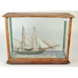 A late Victorian or Edwardian model of a mariners brig in a glass case, length of model 45cm,